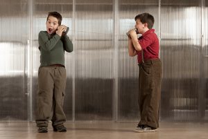 two boys using a tin can phone