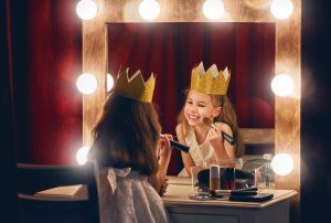 The Actor is the agent or group performing an action in an activity statement. Cute little actress. Child girl in Princess costume on the background of theatrical scenes and mirrors.